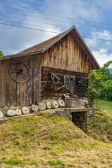 Old wooden house showing millstones and traditional craft