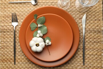 Beautiful table setting with autumn decor on wicker mat, flat lay