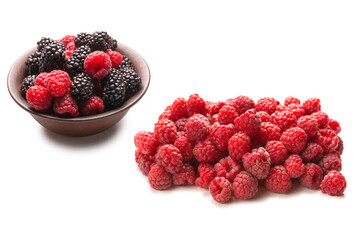 Raspberry, blackberry and mint leaf in ceramic brown bowl isolated on white