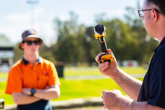 man holding drill tool during trainings session demonstration for young trade apprentices