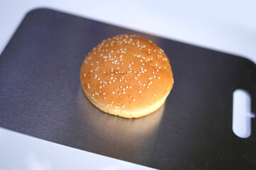 Hamburger on a cutting board on white