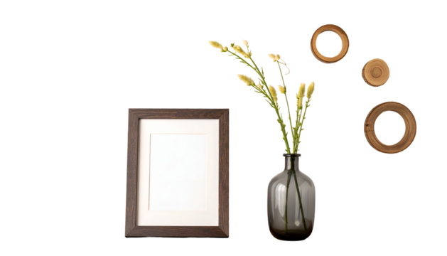 A framed, blank picture, flowers in a vase, and circular wood decor set against black - Powered by Adobe