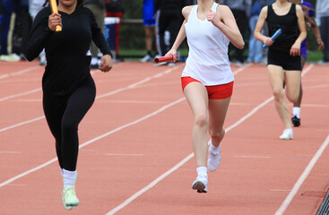 Relay Race at Track Meet With Runners in Action