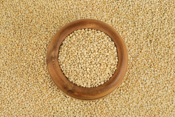 white quinoa seeds in wooden bowl as a background. Top view. Flat lay