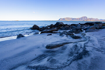 Obraz premium Autumn landscape in Lofoten Islands, Northern Norway, featuring colorful foliage, and a peaceful fjord.