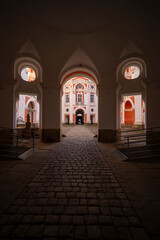 Broumov Monastery archway leading to sunny courtyard