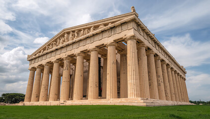 Stately Temple with Columns Against Dramatic Cloudy Sky