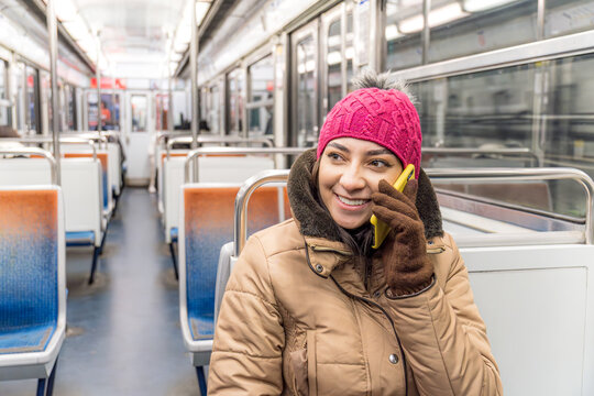 Woman speaks on phone while traveling on the train