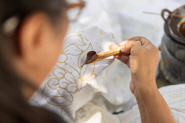 Traditional Indonesian batik wax application close-up