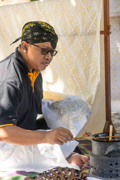 Traditional Indonesian batik creation process in action