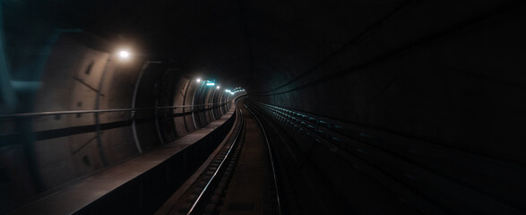 Curved subway tunnel with track lights in Copenhagen