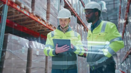 Two male engineers wearing helmets and reflective jackets standing in warehouse. People holding tablet device with digital data projection. Workers analyzing inventory and discussing logistics. - Powered by Adobe
