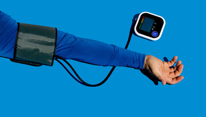 Blood pressure monitor on blue background