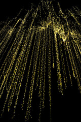 Golden lights cascading strings sparkle bokeh glowing night black background festive abstract