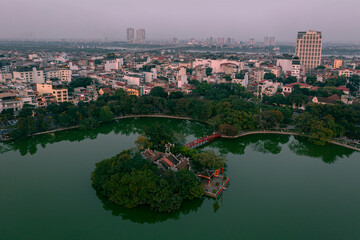 Fototapeta premium The Iconic Turtle Tower (Tháp Rùa) on Hoan Kiem Lake, Hanoi - Aerial Photo Stunning High-Resolution Aerial: Turtle Tower, Hanoi's Legendary Landmark Hoan Kiem Lake's Centerpiece: Turtle Tower Drone 