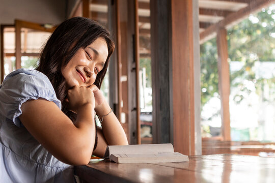 Asian teenager enjoying peaceful moment in cafe
