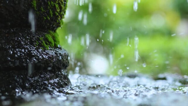 Water flowing on a moss covered stone fountain. Serene spa like atmosphere, Relaxation, Wellness, Refreshing and peaceful mood. Perfect for nature videos and backgrounds