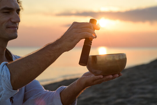 Meditation with Tibetan singing bowl at sunset