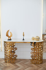 A table with a metallic gold underframe. Luxurious minimalist interior. White and gold palette,