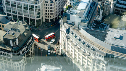 Red buses crossing busy street in London's City District