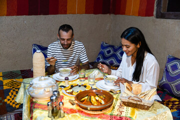Couple dining in traditional Berber tent in Morocco