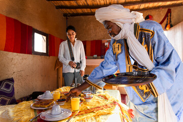 Woman with nomad in traditional Berber tent