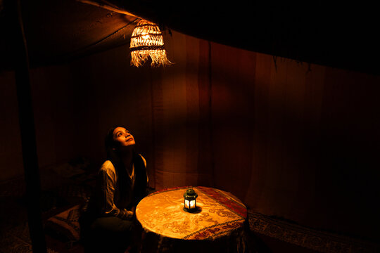 Woman in traditional desert camp in Merzouga landscape