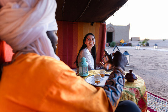 Woman enjoying a serene moment in Sahara nomadic camp