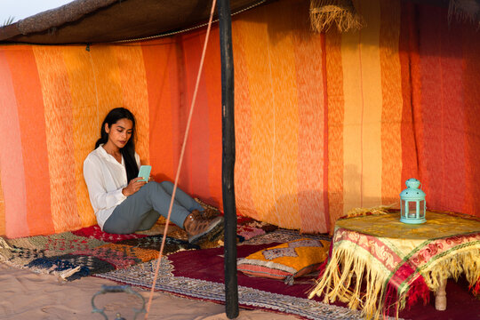 Traveler in traditional Berber tent in Sahara camp