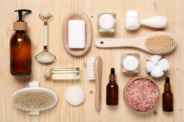 Flat lay composition with spa products and burning candles on wooden table