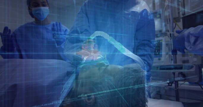 Staff in gowns adjusting oxygen mask and tube on patient in ER, grid overlay and monitors