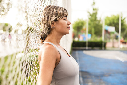 Woman exercising outdoors on a sports court
