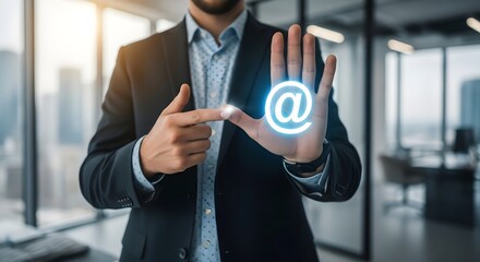 Businessman's hand holding an email symbol is a concept of communication and success in business