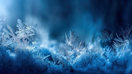 Close up view of frosted snowflakes on a winter surface with blue background