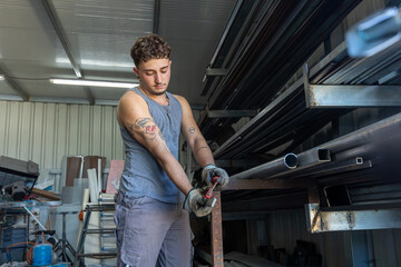 Trans man working confidently in an industrial setting