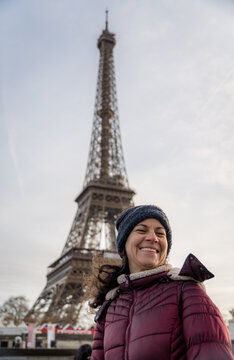 Smiling woman enjoying Parisian atmosphere in winter