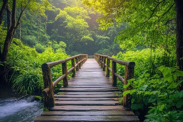 Obraz premium serene wooden bridge stretches over stream, surrounded by vibrant green foliage. early morning light filters through trees, creating peaceful atmosphere perfect for nature lovers