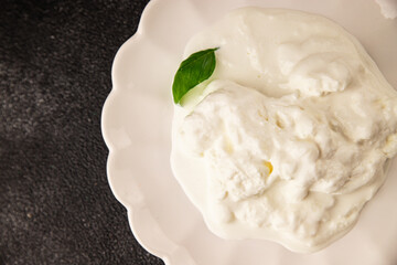 Stracciatella cheese soft young portion size Italian food natural product tasty snack fresh delicious gourmet food background on the table rustic top view copy space