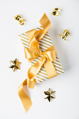 Merry Christmas and Happy Holidays greeting card, frame, banner. New Year. Golden Christmas decoration and gifts, presents on white background top view. Xmas holiday festive theme.	
