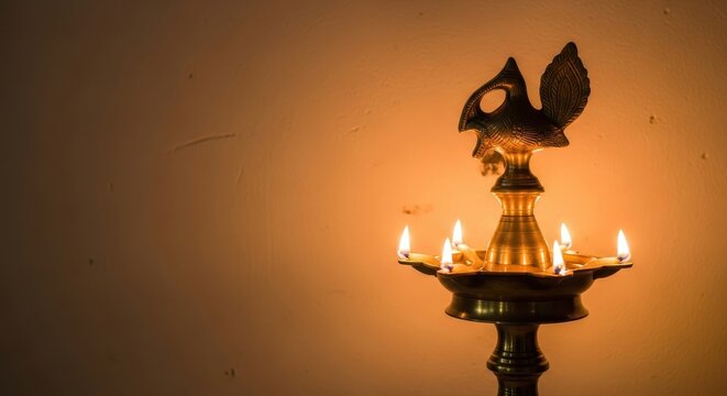 traditional indian brass oil lamp, or samai, with multiple wicks burning brightly. it casts warm golden glow on simple wall. diwali celebration. background, banner.