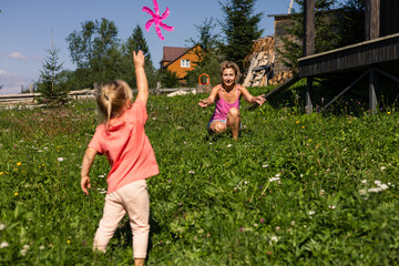 Granddaughter plays frisbee with grandmother in a field