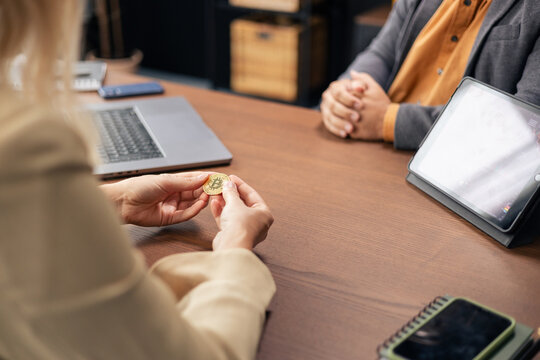 People discussing cryptocurrency investment during a business meeting - Powered by Adobe