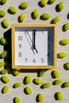 Clock Strikes Midnight with Grapes for New Year Celebration