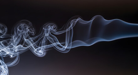 Wispy white smoke curls and twists against a dark background.