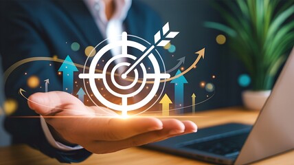 Businessman holding target board with arrow for business achievement goal