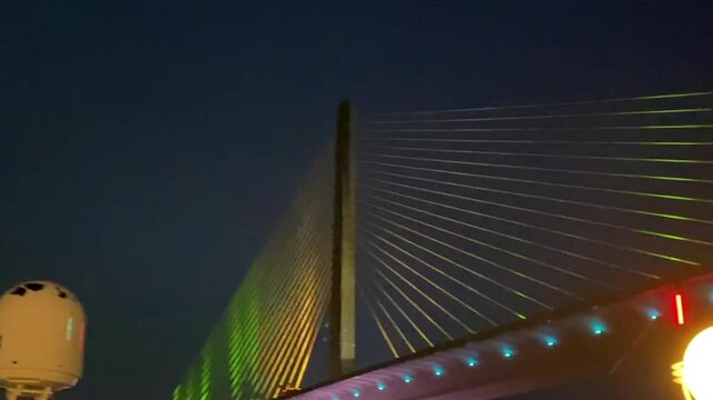 Tampa, Florida: Norwegian Jade cruise ship sailing under the Sunshine Skyway Bridge in Tampa Bay at night.