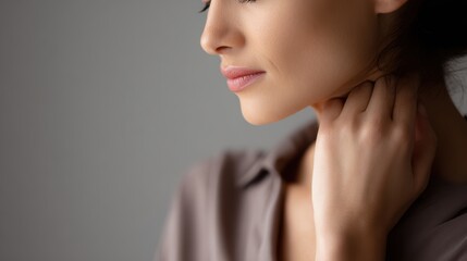 Fototapeta premium Portrait of woman experiencing throat discomfort, highlighting tension and soreness in neck area. Concept of upper respiratory tract infection or laryngeal irritation