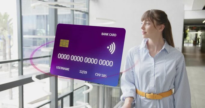Adult woman watching holographic card appearing, rotating in finance revealing chip expiration CVV