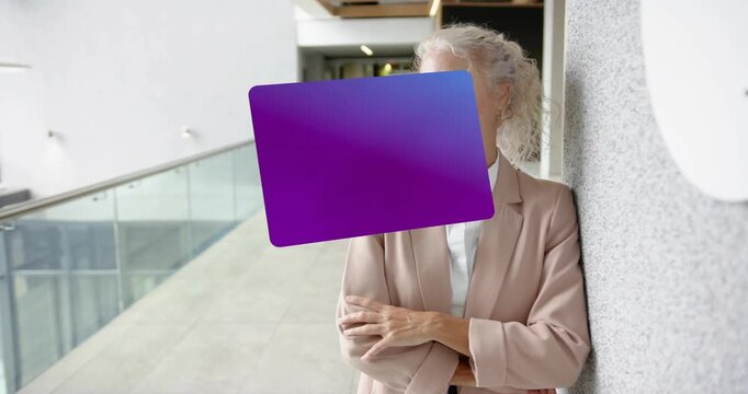 woman leaning wall, eyeing hallway and initiating spinning purple bank card displaying finance info