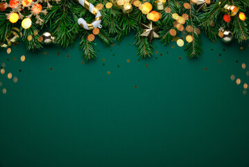 Christmas background with xmas tree, christmas decoration and sparkle bokeh lights on green background. Merry Christmas greeting card. Winter holiday theme. Happy New Year. Space for text